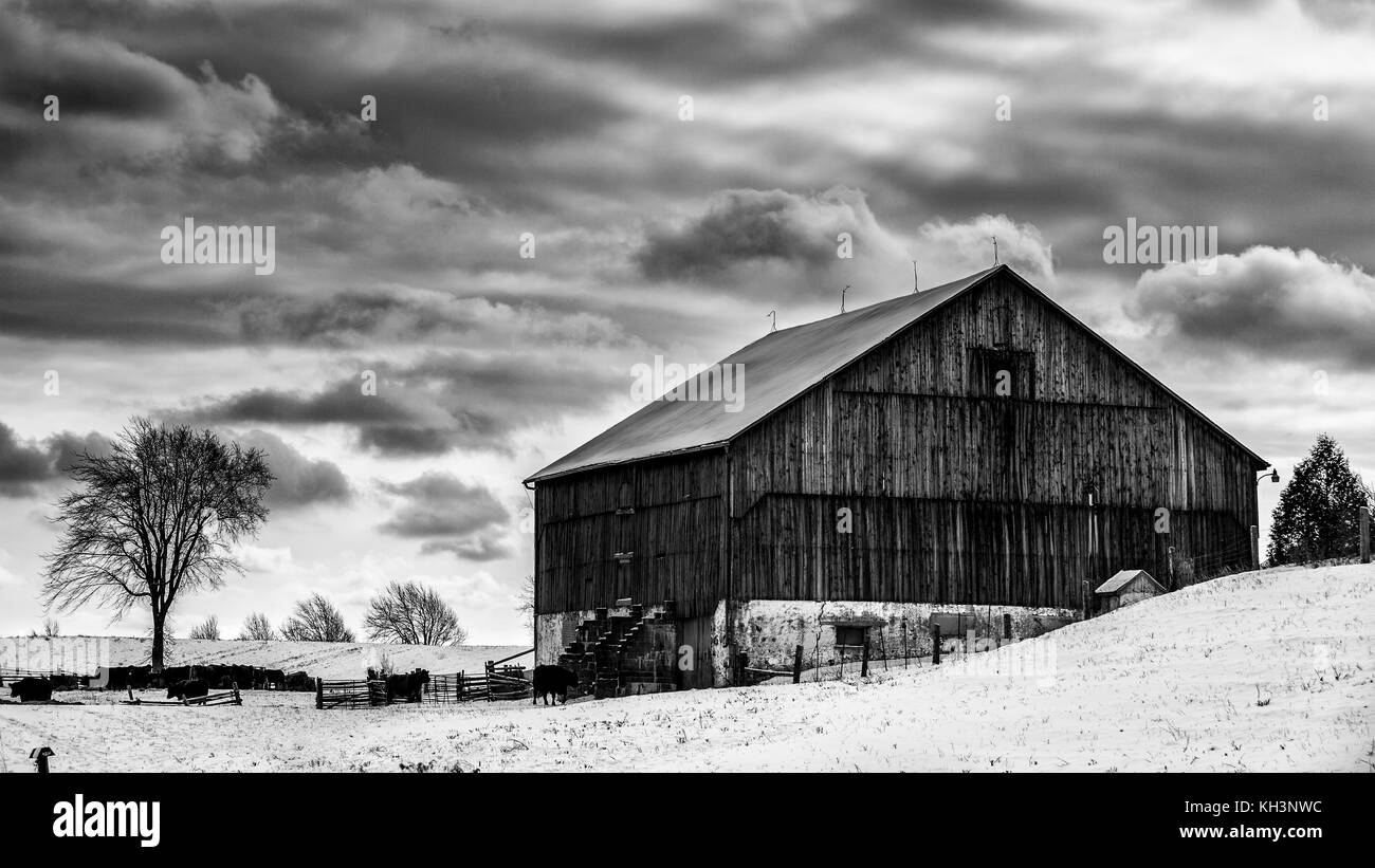 the barn on the hill with those winter clouds Stock Photo