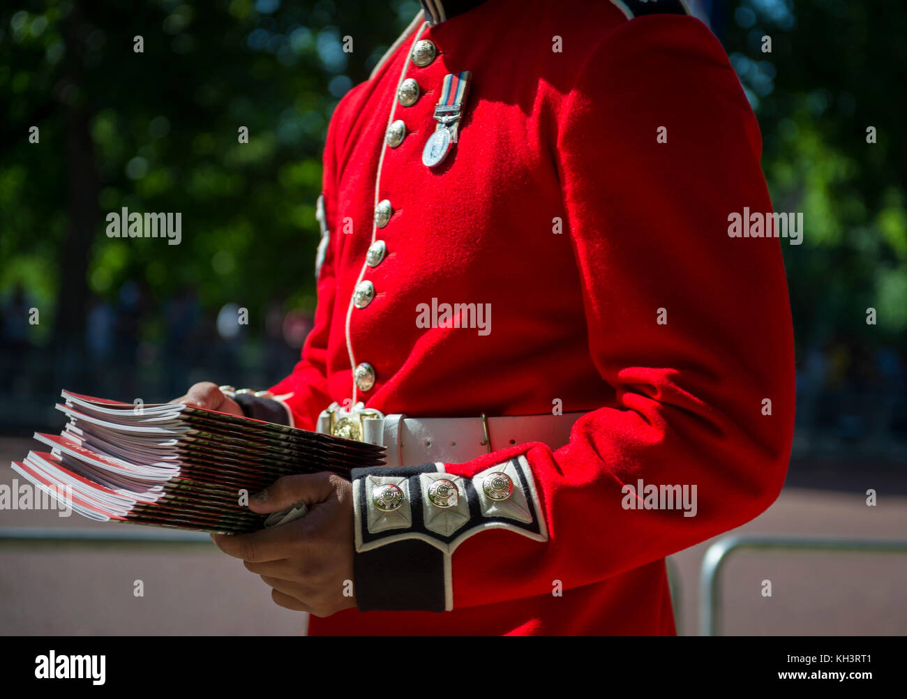 Queen's Royal Guard soldier handing out pamphlets at a celebration in London, England Stock Photo