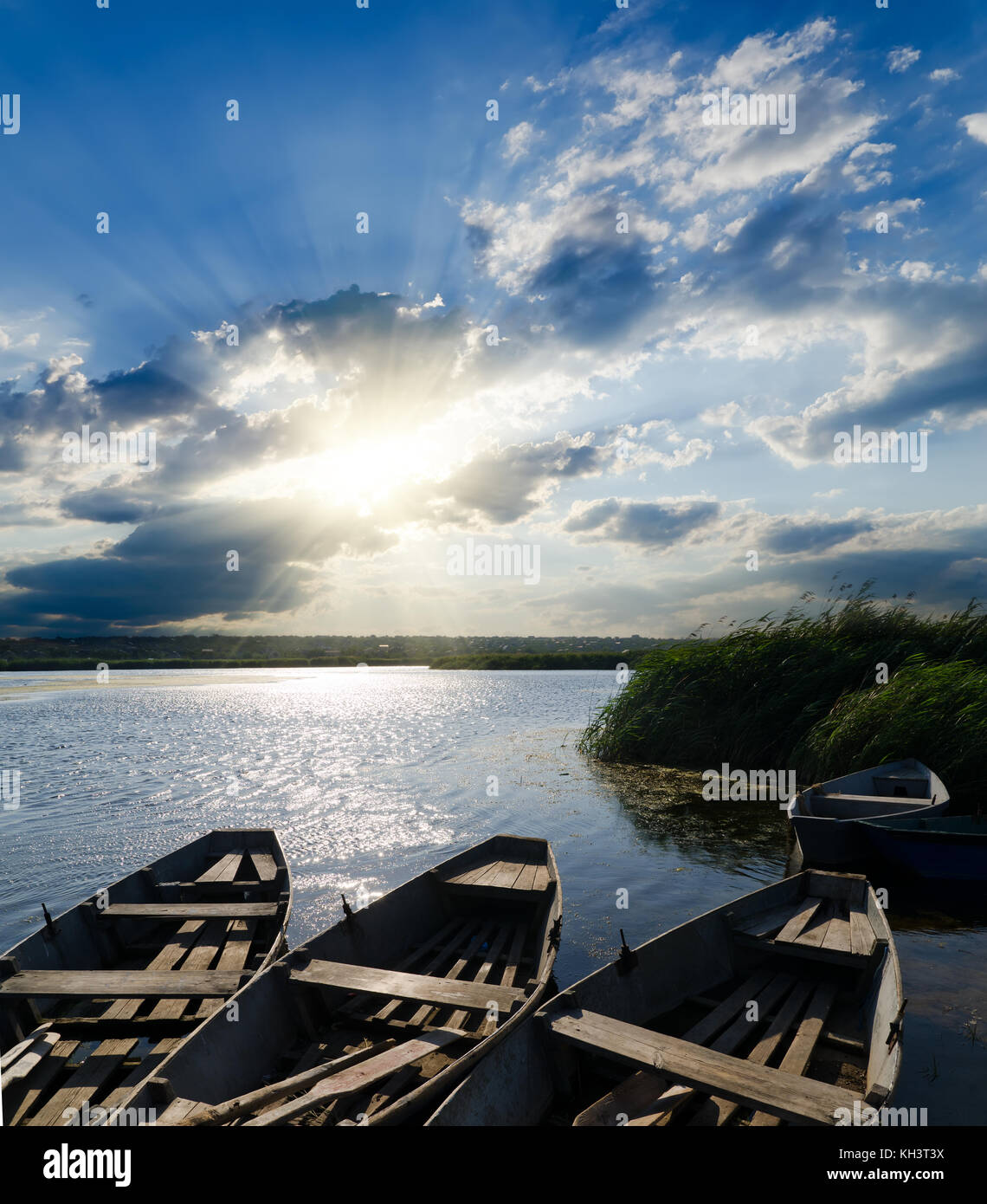 sunset over river with boats Stock Photo - Alamy