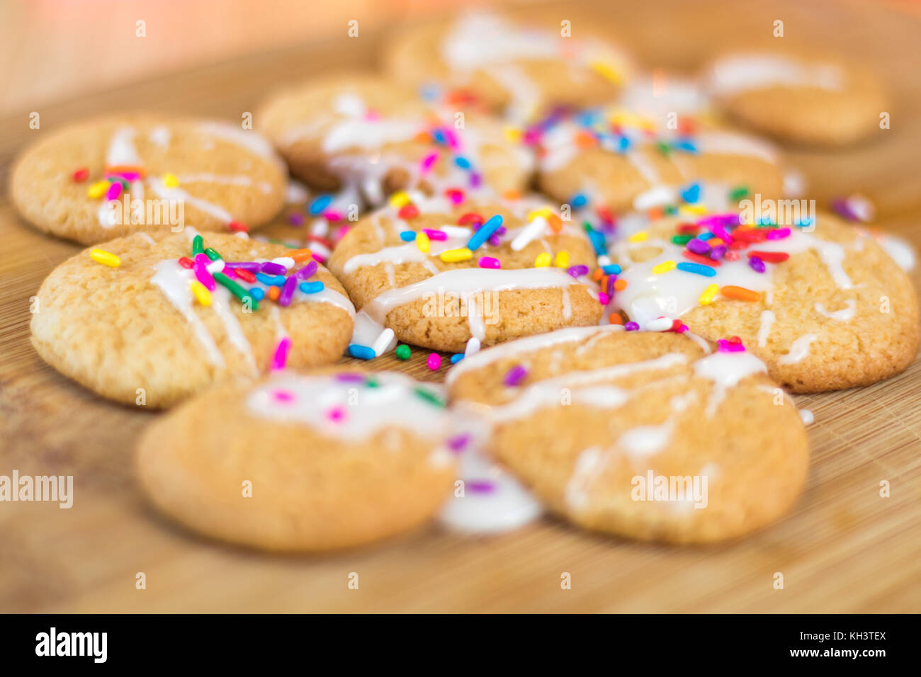 Freshly baked sugar cookies with white icing and rainbow colored