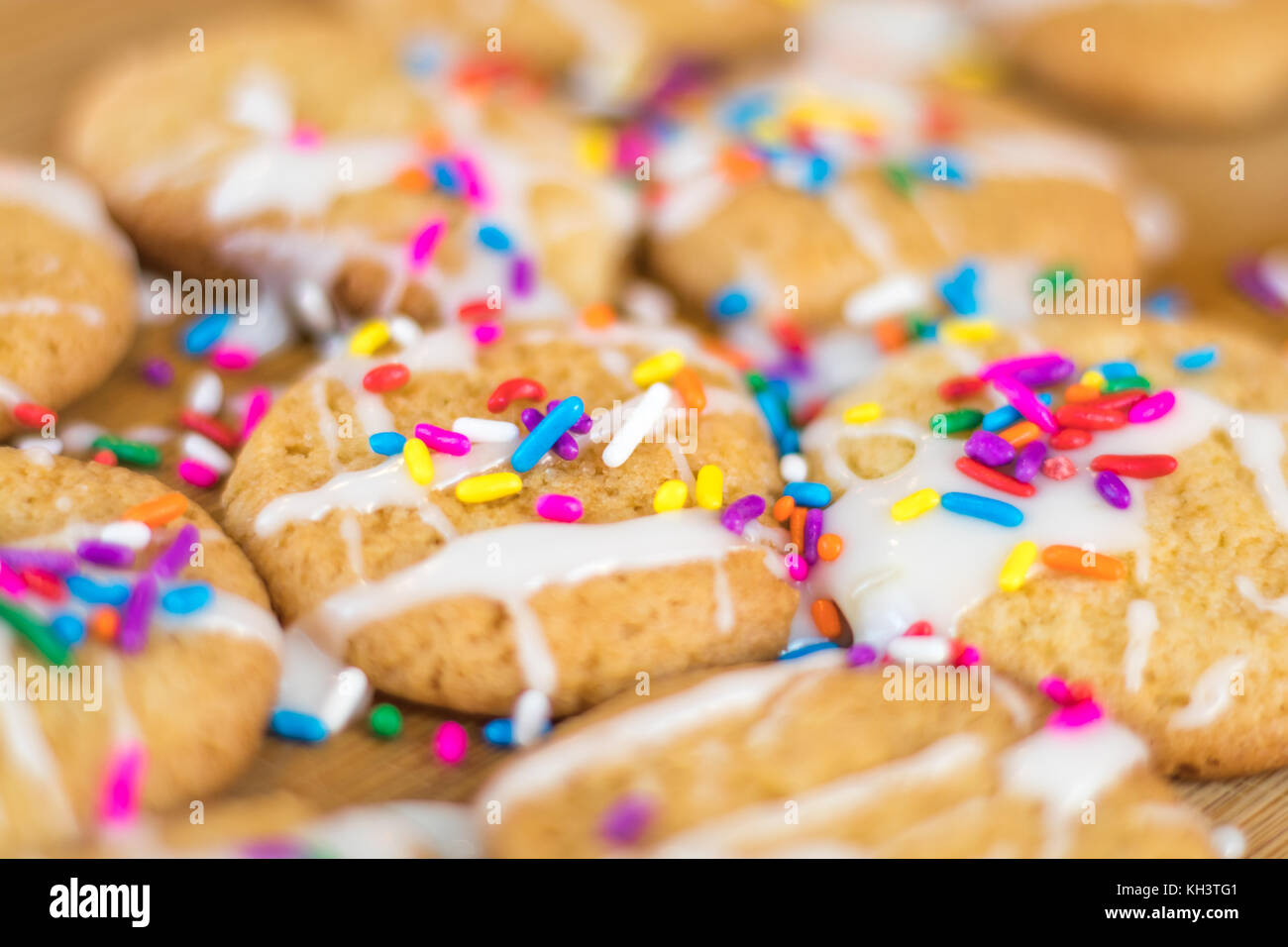 Freshly baked sugar cookies with white icing and rainbow colored