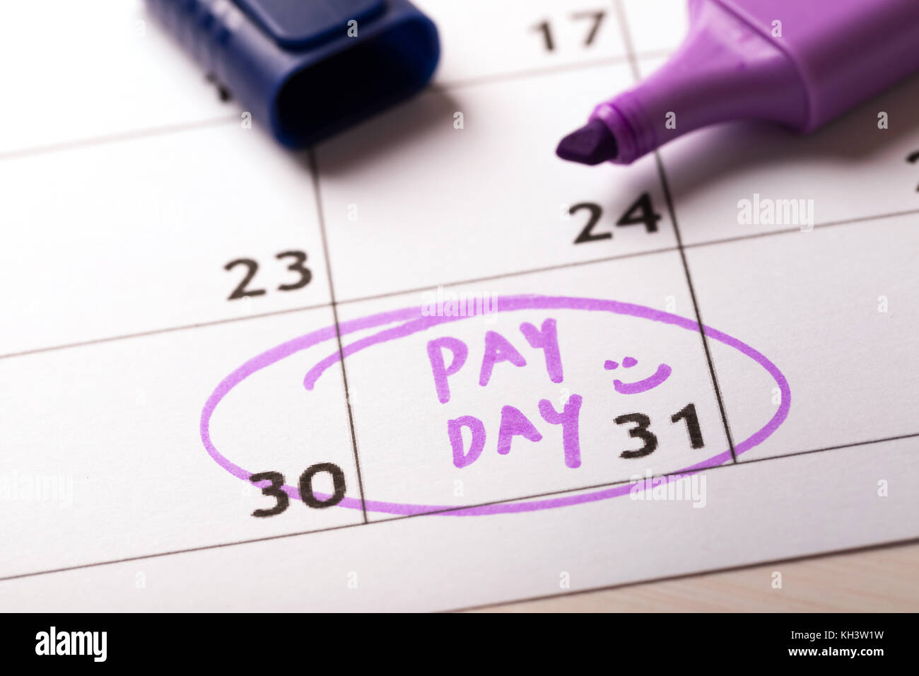 payday concept calendar with marker and circled day of salary Stock Photo