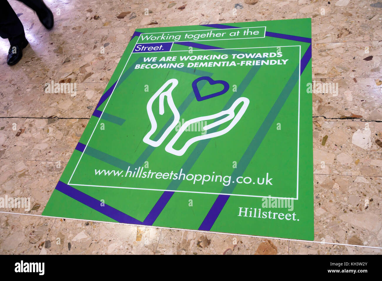 Notice on the floor at the entrance to Hill Street Shopping Centre in