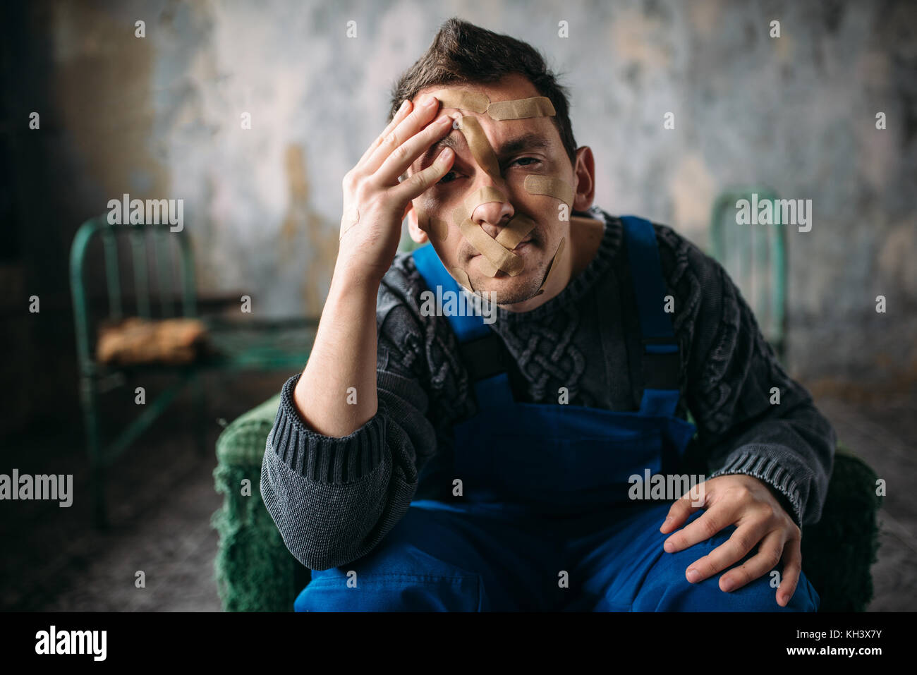 Madman, mouth sealed with plaster, psycho patient Stock Photo