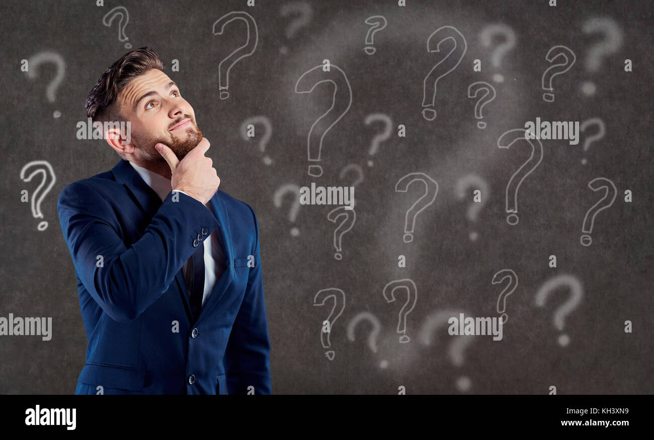 A man in a suit is thinking over a question. Stock Photo