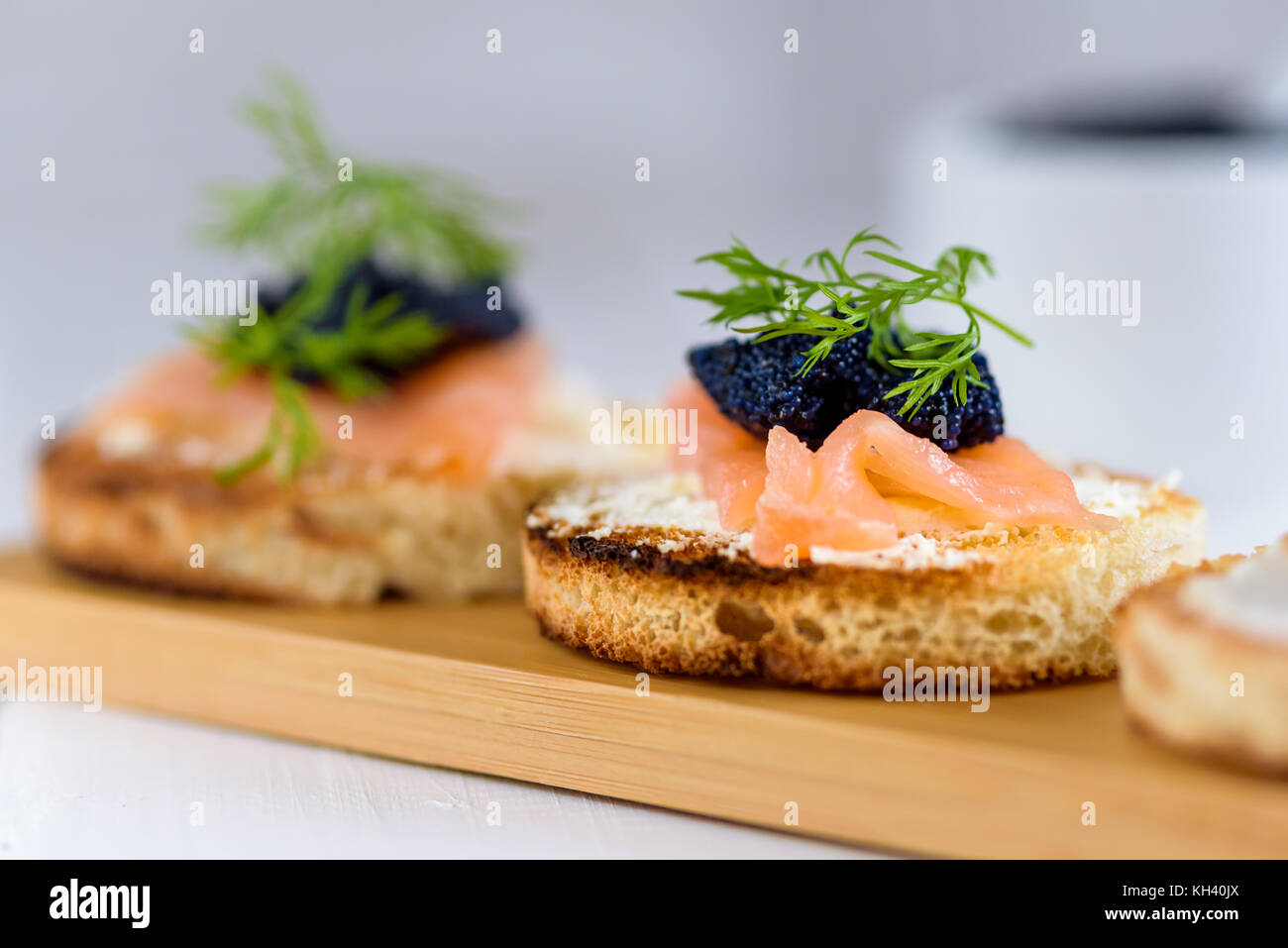 Appetizer toast bread with cream cheese, smoked salmon and black caviar