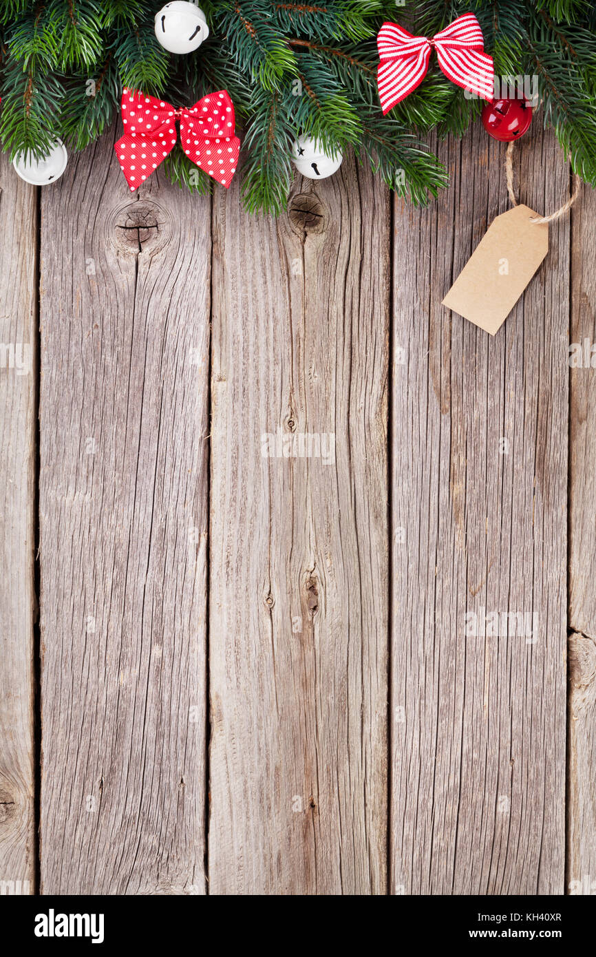 Christmas wooden background with fir tree and ribbon bow decor. View ...