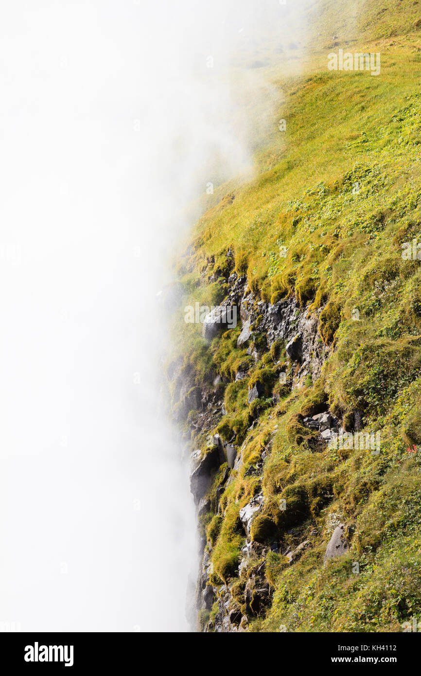 Mist from Gullfoss (Golden Falls) waterfall shrouds the surrounding landscape in Iceland. Stock Photo