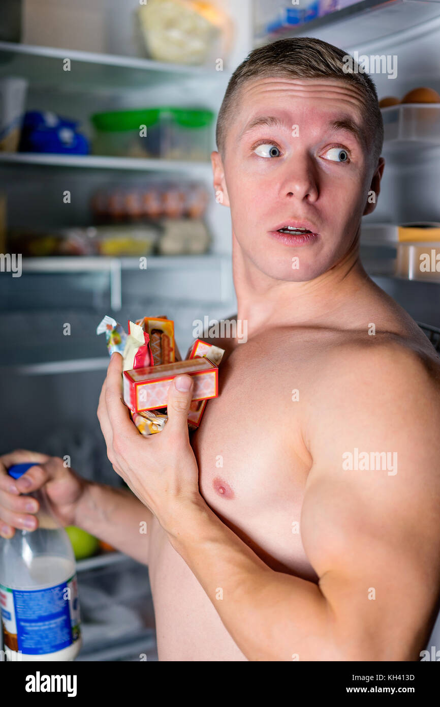 man looking for food in the fridge Stock Photo Alamy