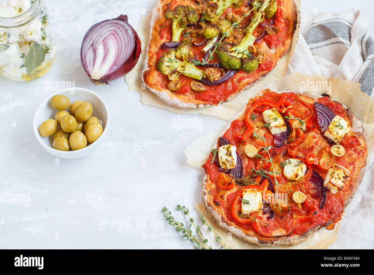 Homemade vegetarian vegetable pizza with feta cheese and broccoli. Vegan Healthy Food Concept. Stock Photo
