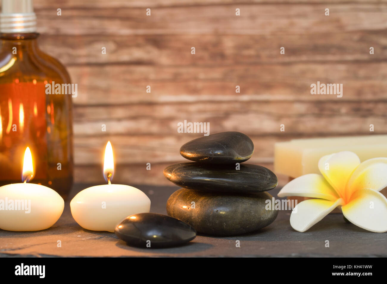 wellness and spa composition candles with massage stones Stock Photo
