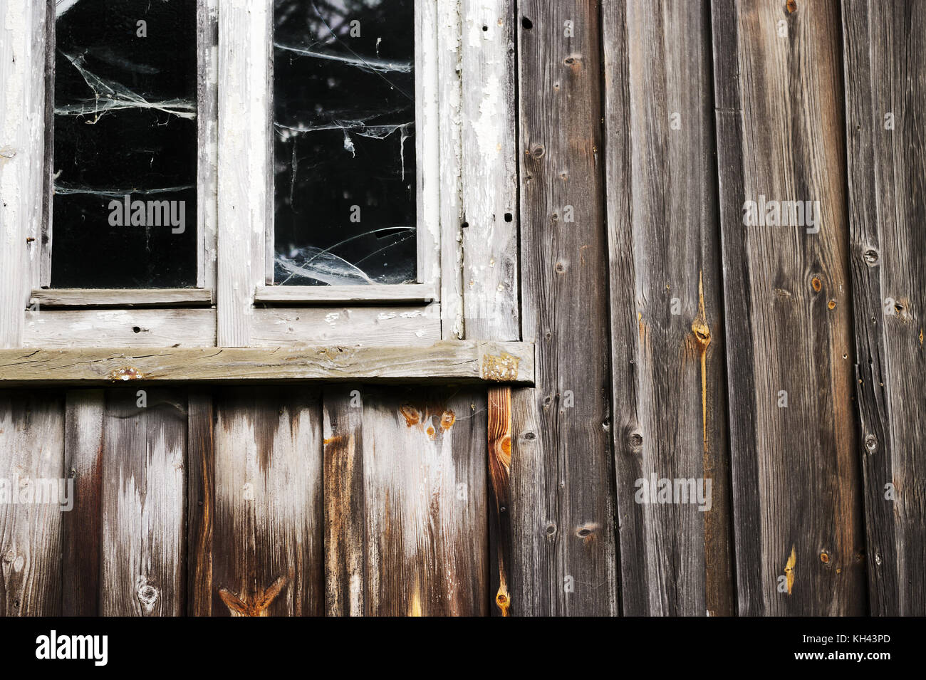 Window and wall of the old abandoned wooden house. Details of vintage wall and window frames. Sudetes, Poland. Stock Photo