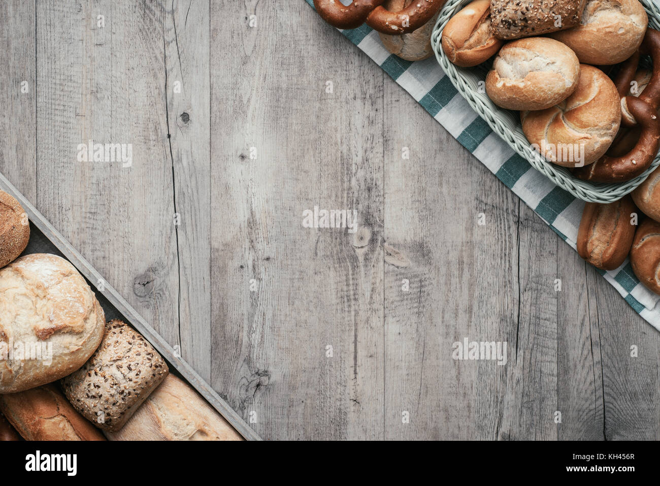 Freshly baked variety of bread on a rustic wooden worktop, vintage ...