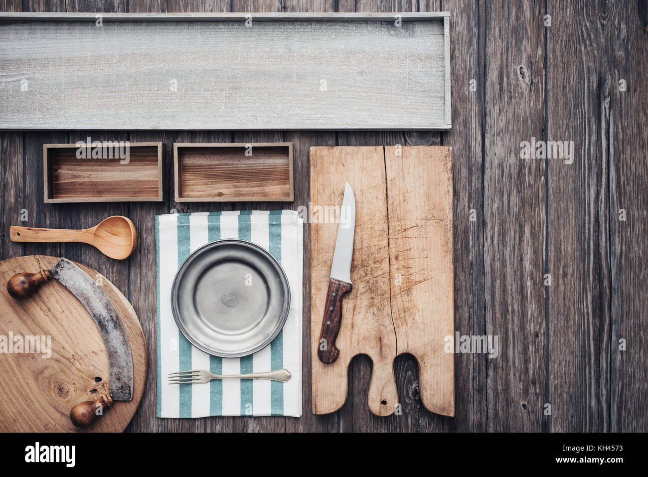 https://c8.alamy.com/comp/KH4573/rustic-vintage-kitchen-wooden-worktop-with-utensils-old-chopping-boards-KH4573.jpg