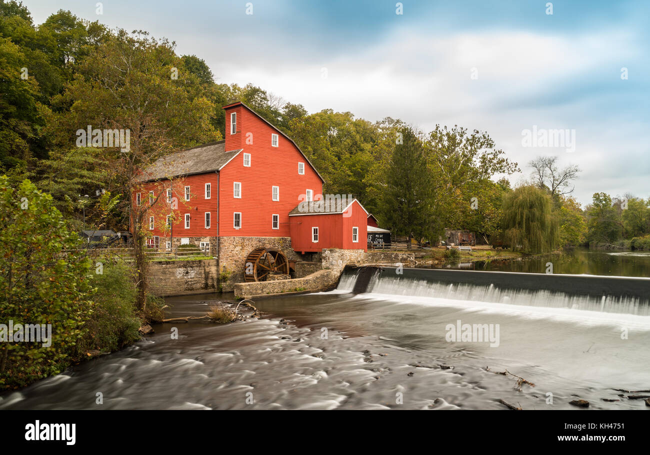 The historic Red Mill in Clinton NJ with people fishing in the river. The village also decorated for halloween as  photo taken in Mid October Stock Photo