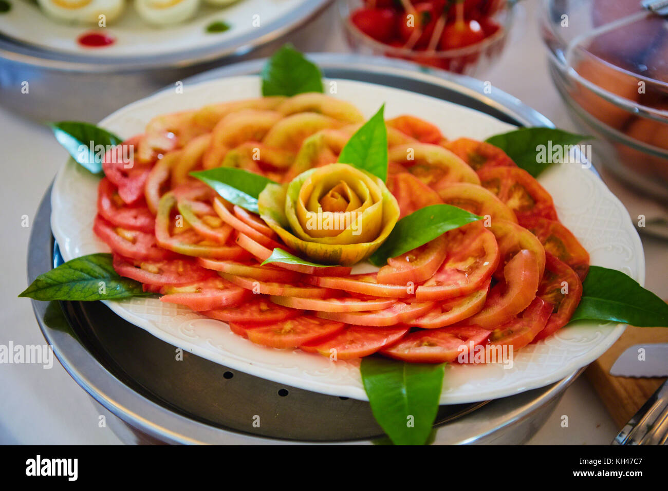 Close Up View of Slices of Fresh Tomato arranged on a Plate Artfully, Positano, Italy Stock Photo