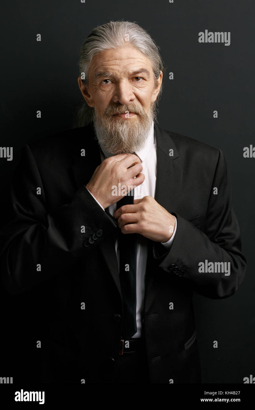 Beardy old man wearing business suit. Stock Photo