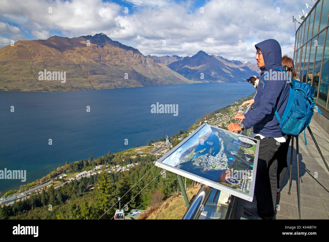 Man on the viewing deck of the Skyline Gondola above Queenstown Stock Photo