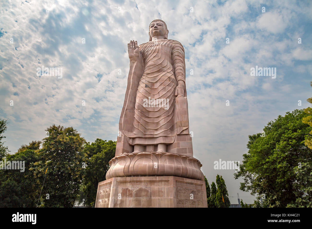Gigantic sculpture of standing Buddha 80 feet tall at Wat Thai monastery Sarnath, Varanasi, India. Stock Photo