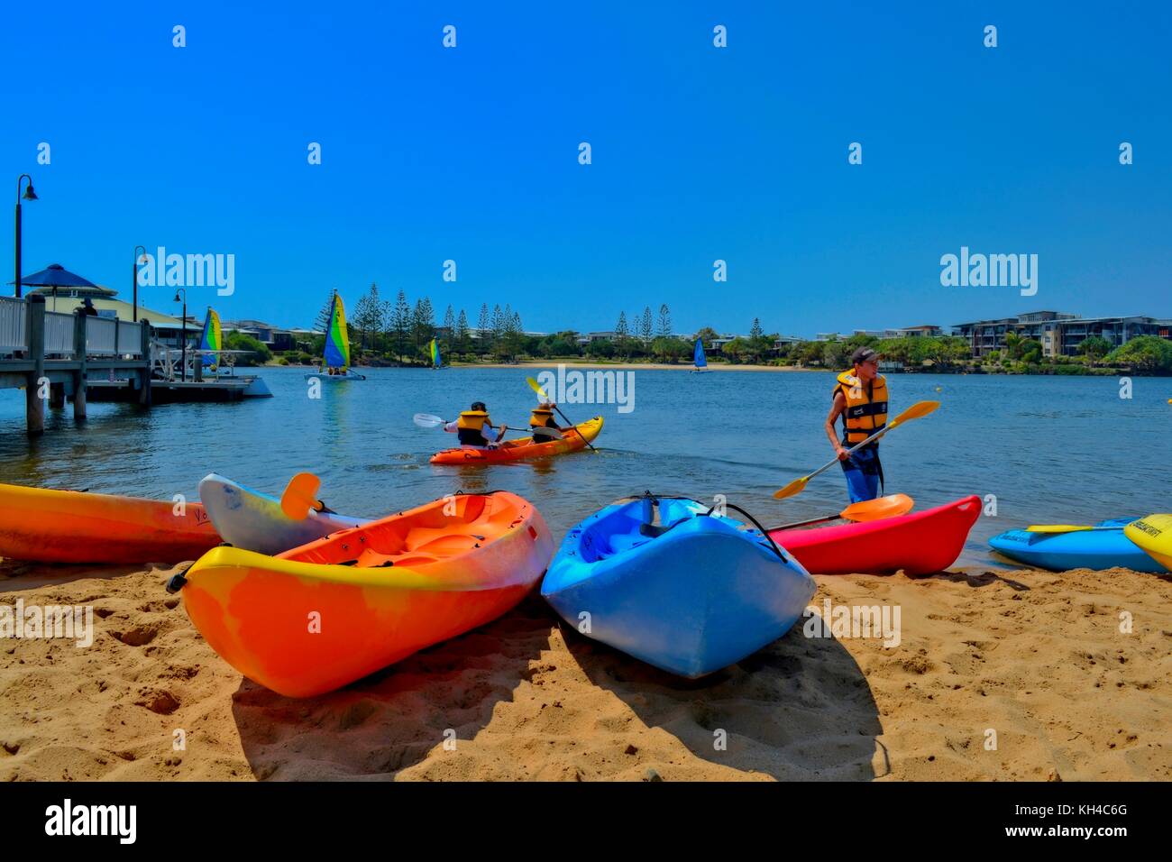 Twin Waters, Sunshine Coast, Australia - January 2014: People paddle a kayak on a lake. Stock Photo