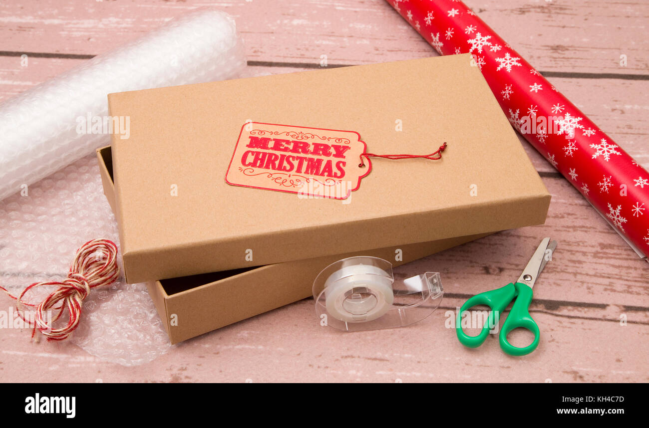 Wrapping Holiday Gifts in a Kraft Box Stock Photo