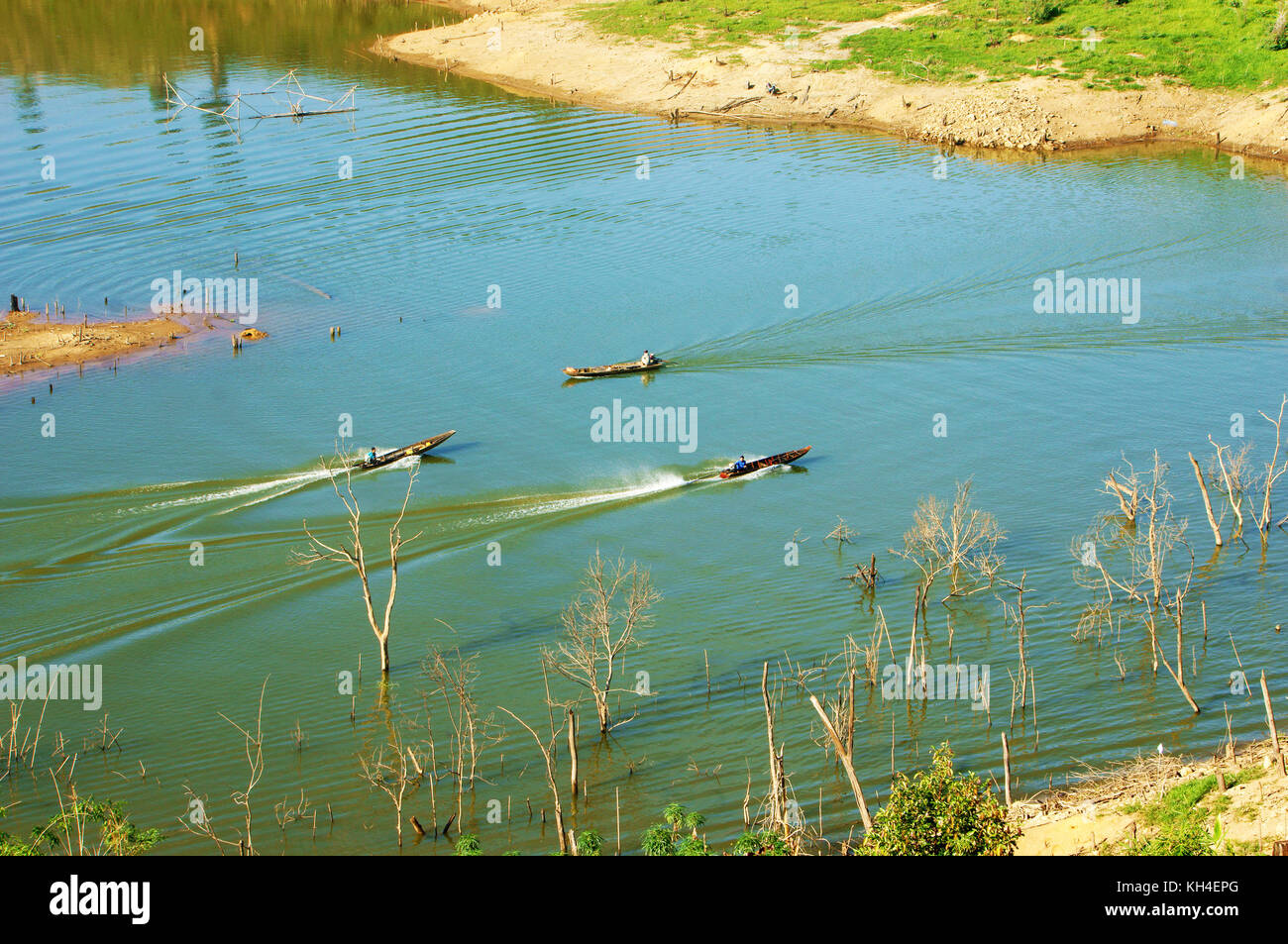 Three man moving fast forward on motor boat as boat race, boat make wave pattern on surface water at Nam ka lake, Dak lak, Viet Nam Stock Photo