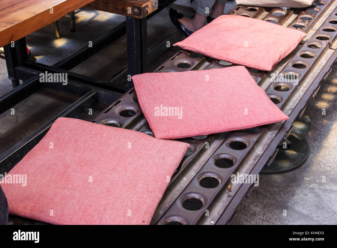 long steel metal bench adapted from industrial manufacturing process
