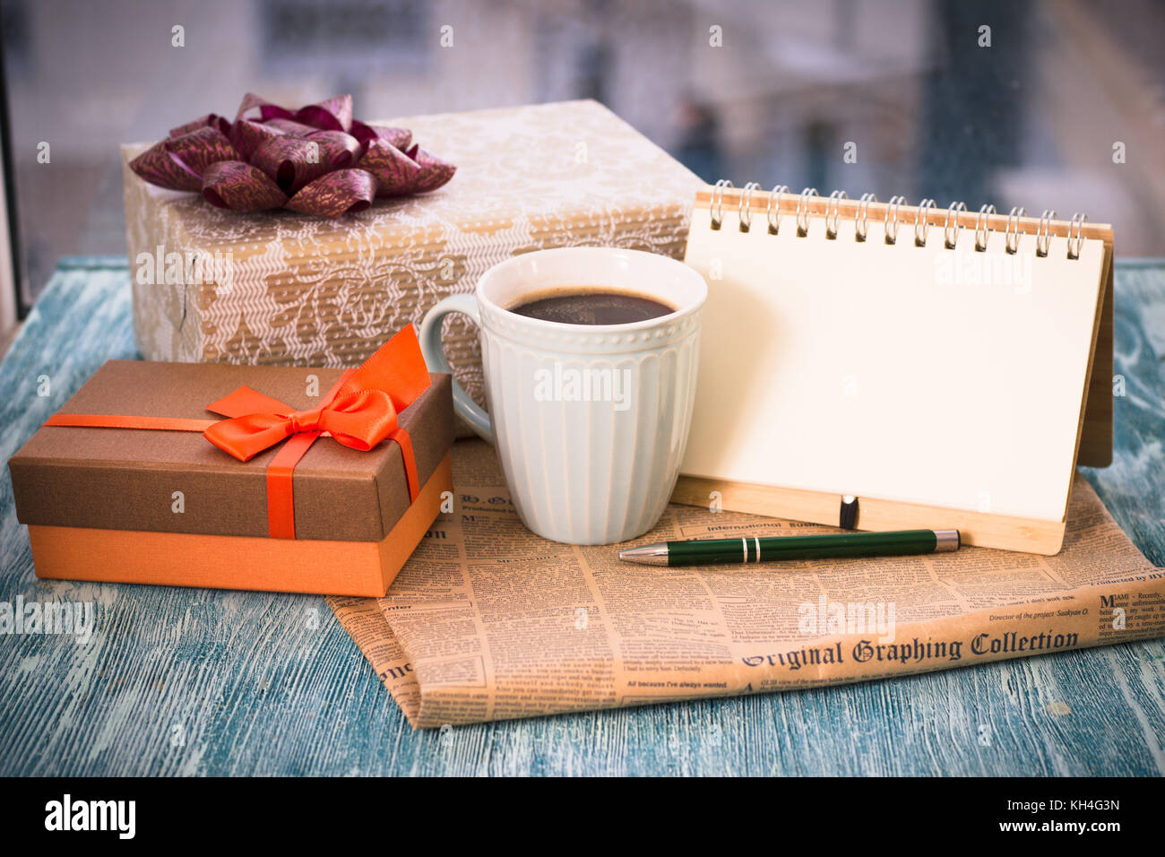 Festive still life with gifts, a cup, a notebook and a pen Stock Photo