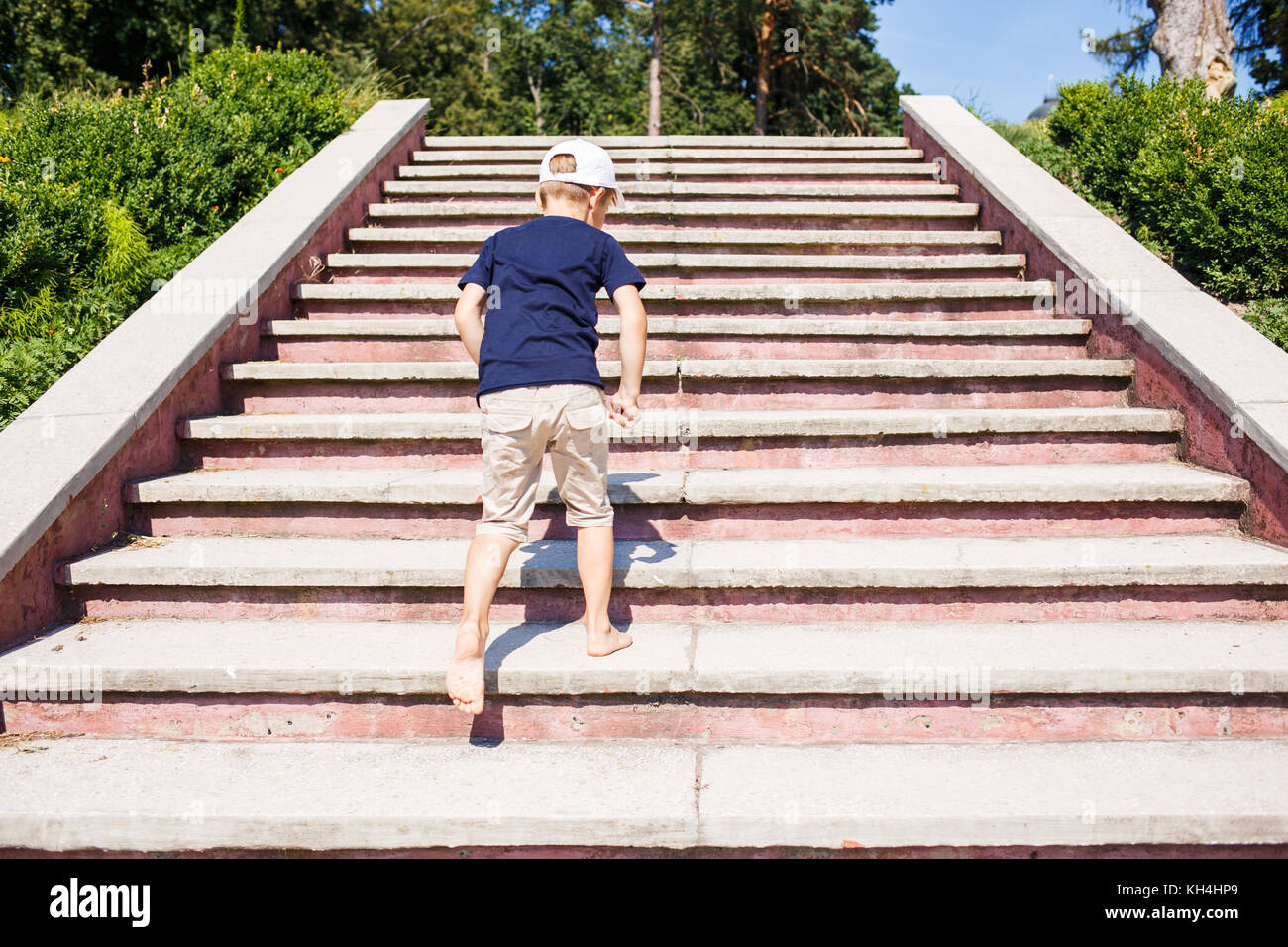 Children going up on stairs barefoot. Concept childhood image with copy