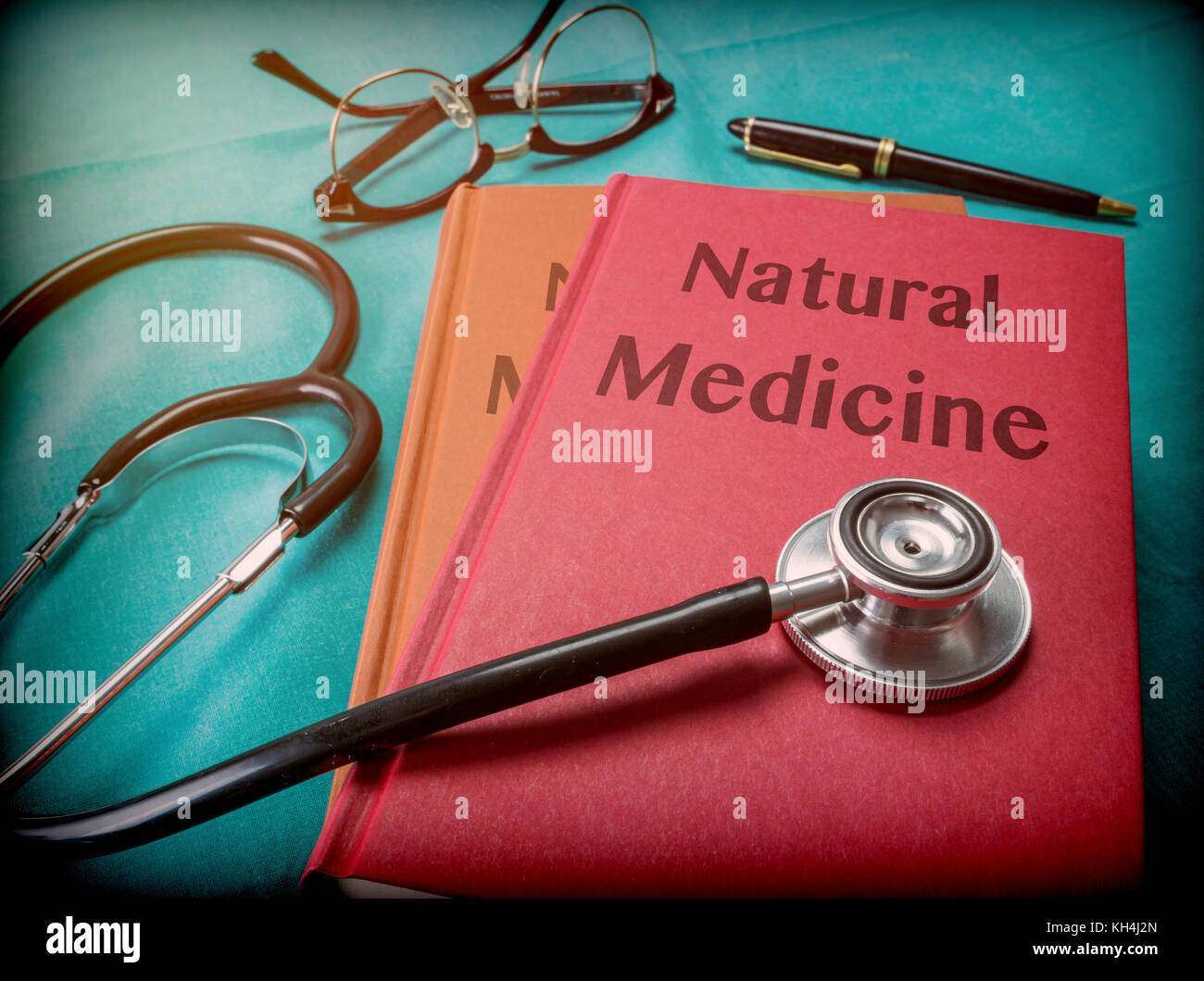 Doctor supports a book of natural medicine in a medical laboratory Stock Photo