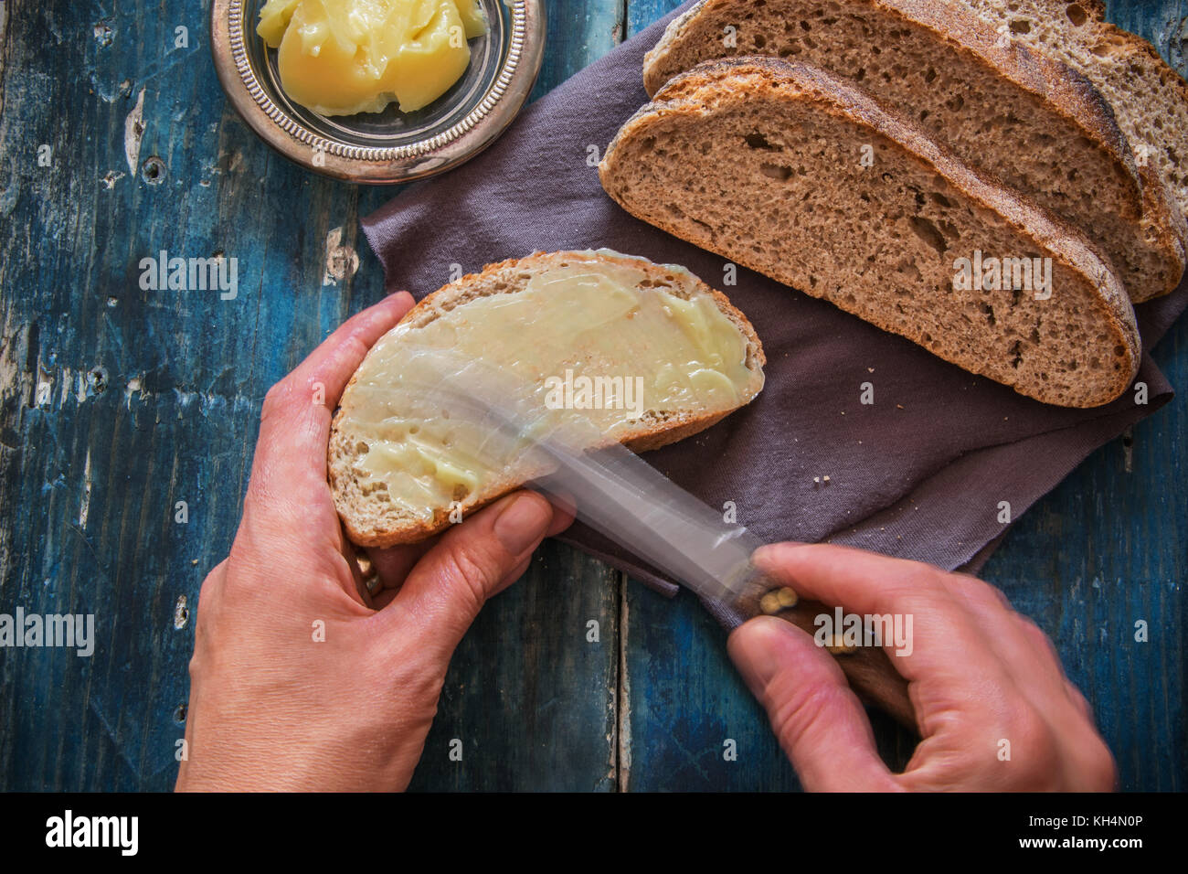 Spread fresh butter on whole wheat bread Stock Photo Alamy