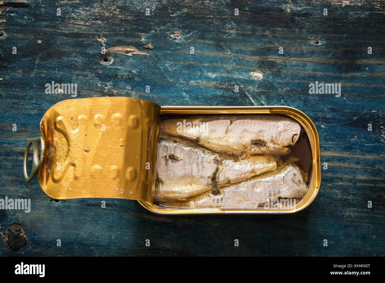Sardines in the can on blue wooden table Stock Photo Alamy