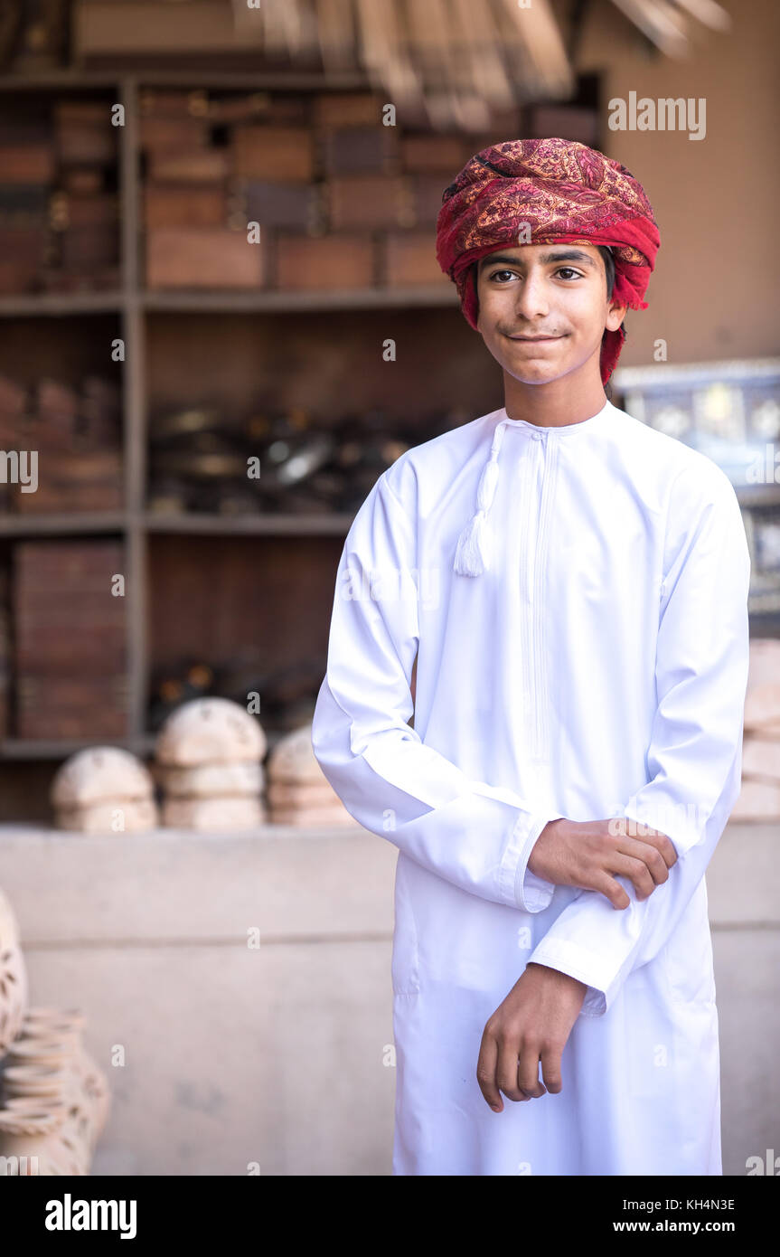 Portrait of a young Omani boy in a traditional outfit. Nizwa, Oman. Stock Photo