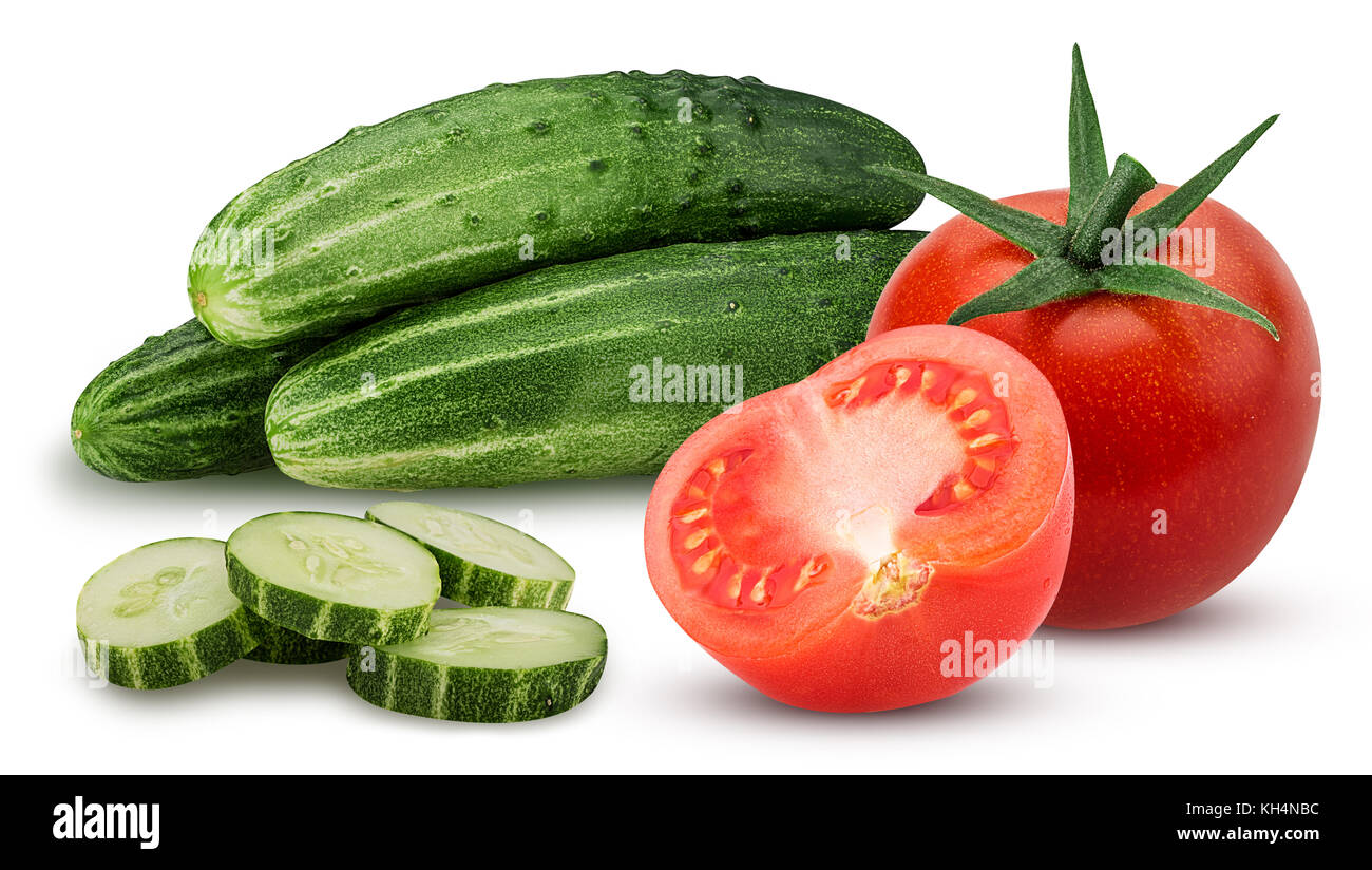 Three cucumber with chopped and whole tomato and one cut in half isolated on white background. Clipping Path. Full depth of field. Stock Photo