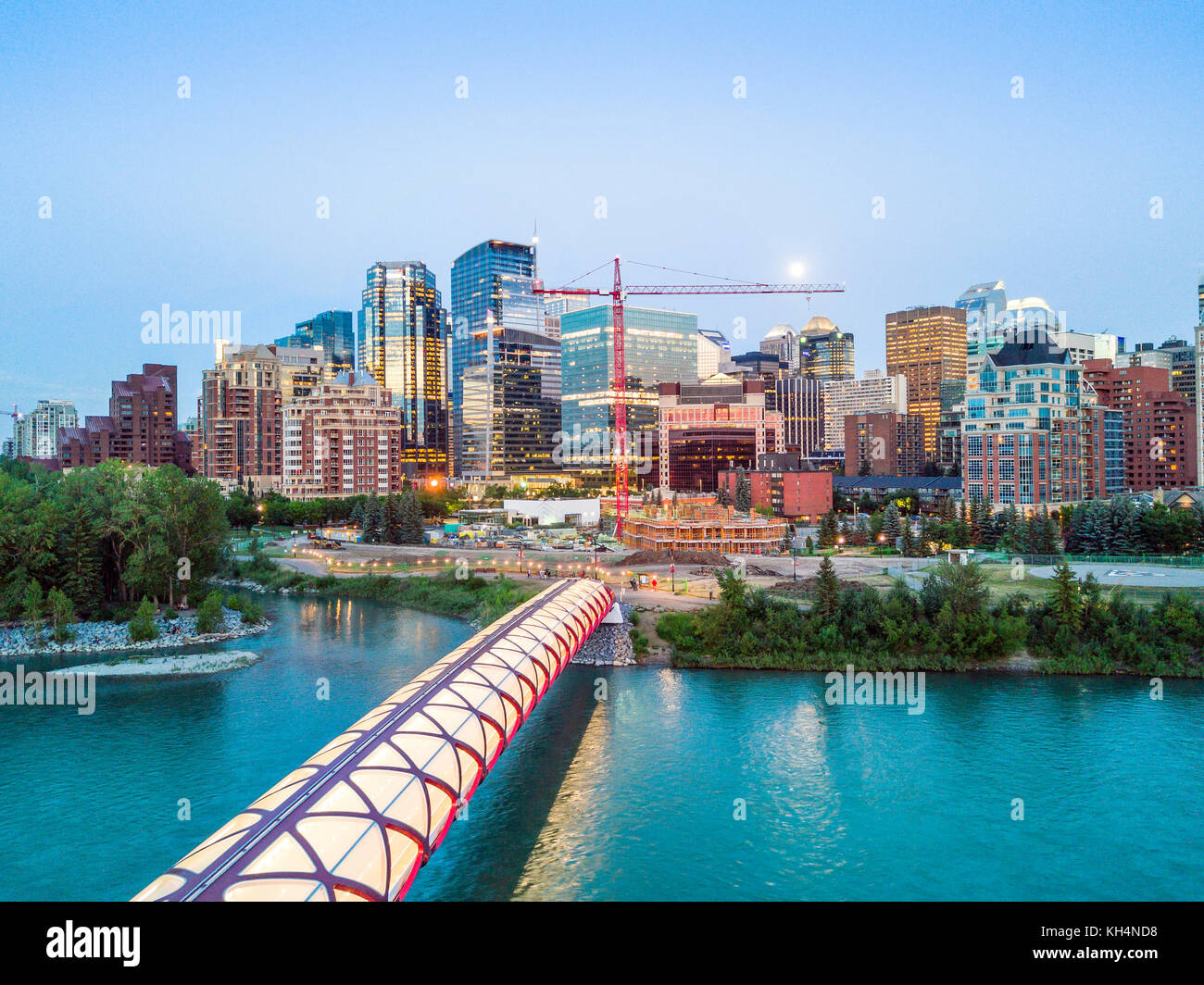 Calgary downtown with iluminated Peace Bridge and full moon, Alberta, Canada Stock Photo