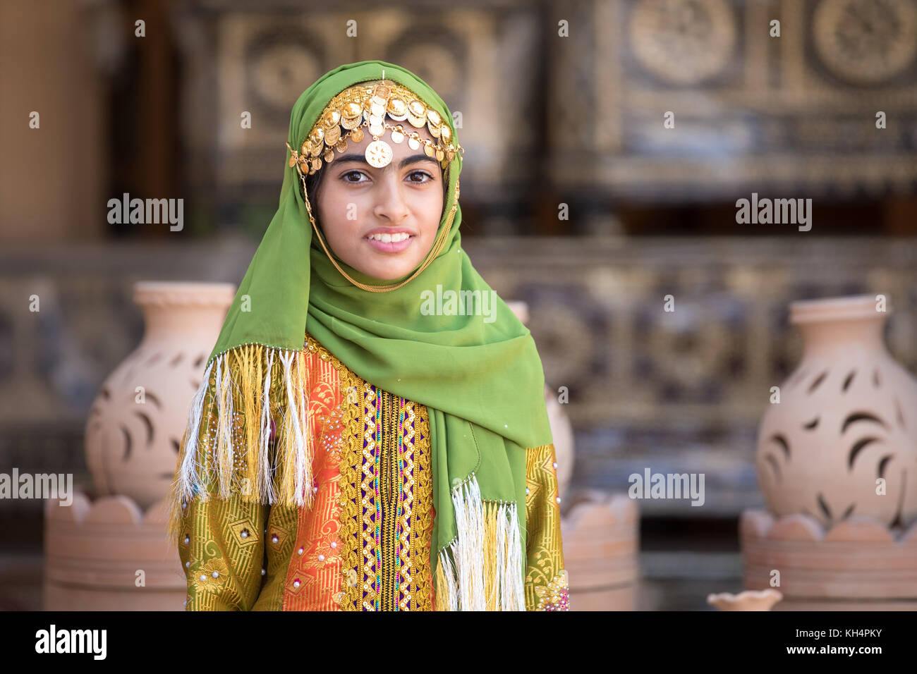 Portrait of a young Omani girl in the traditional Omani outfit. Nizwa, Oman. Stock Photo