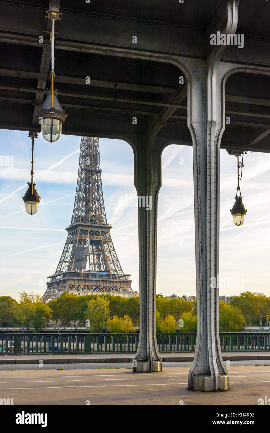 The Eiffel tower seen from the Bir-Hakeim bridge with the Art Deco street lights and the metal pillars supporting the subway track in the foreground. Stock Photo