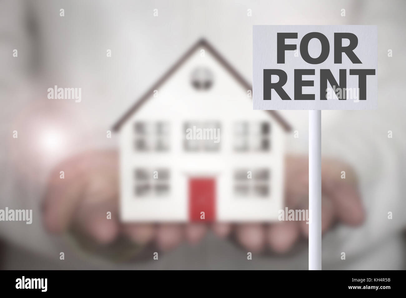 For rent sign with hands holding a small house in the background Stock ...