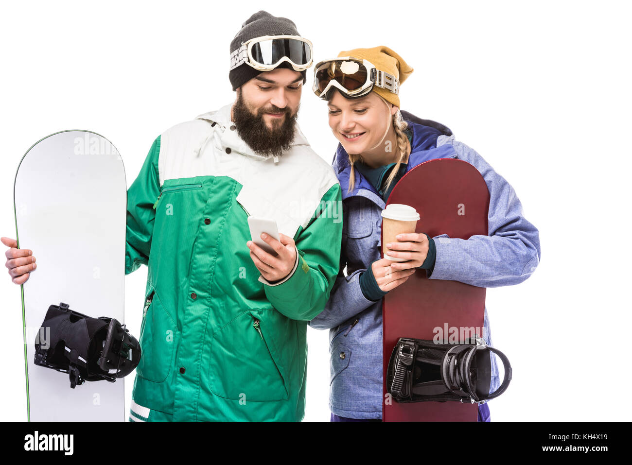 couple with snowboards using smartphone Stock Photo