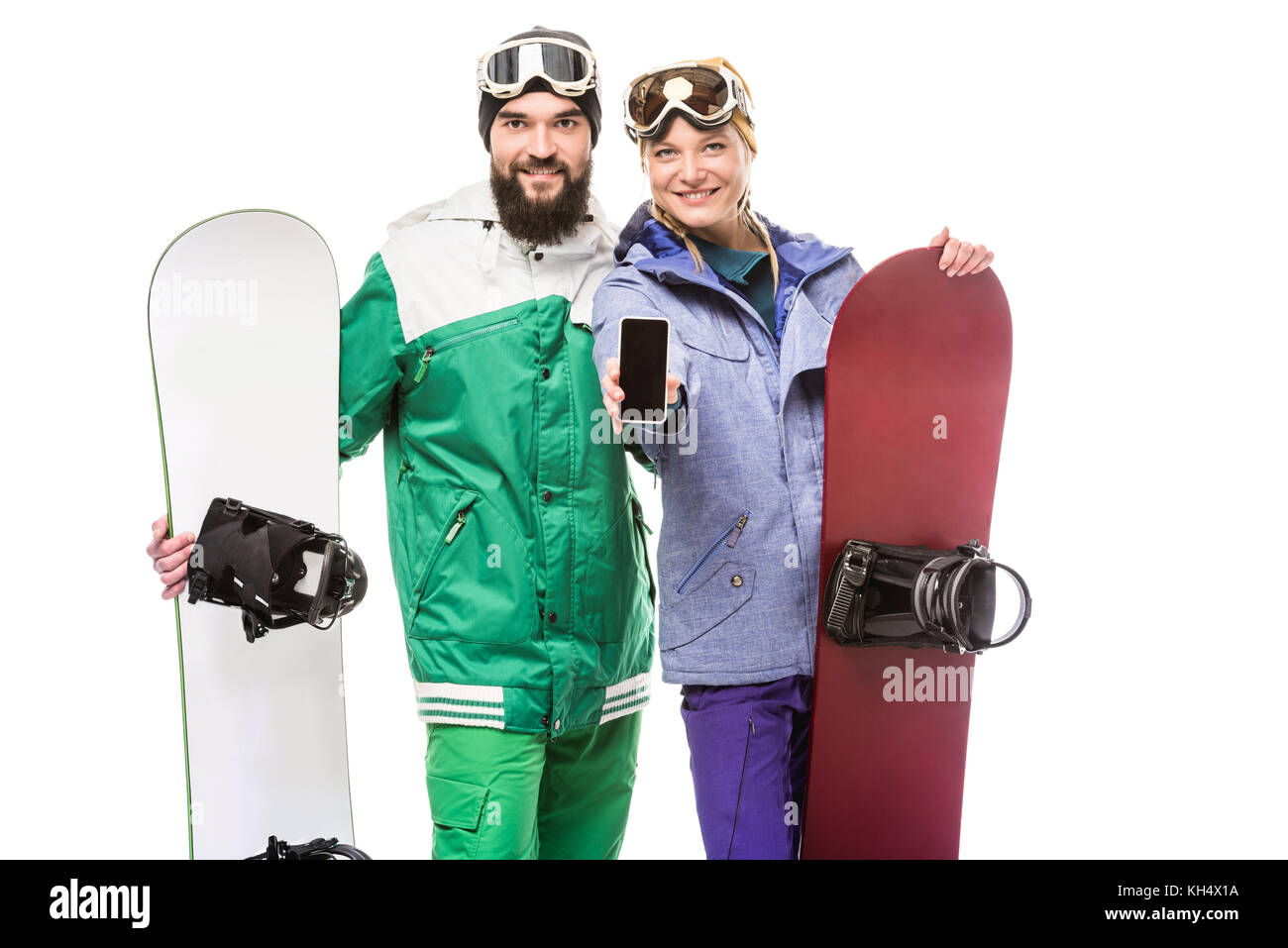 couple with snowboards showing smartphone Stock Photo