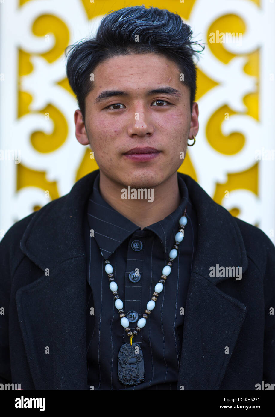 Portrait of young and fashionnable tibetan man, Tongren County, Rebkong, China Stock Photo