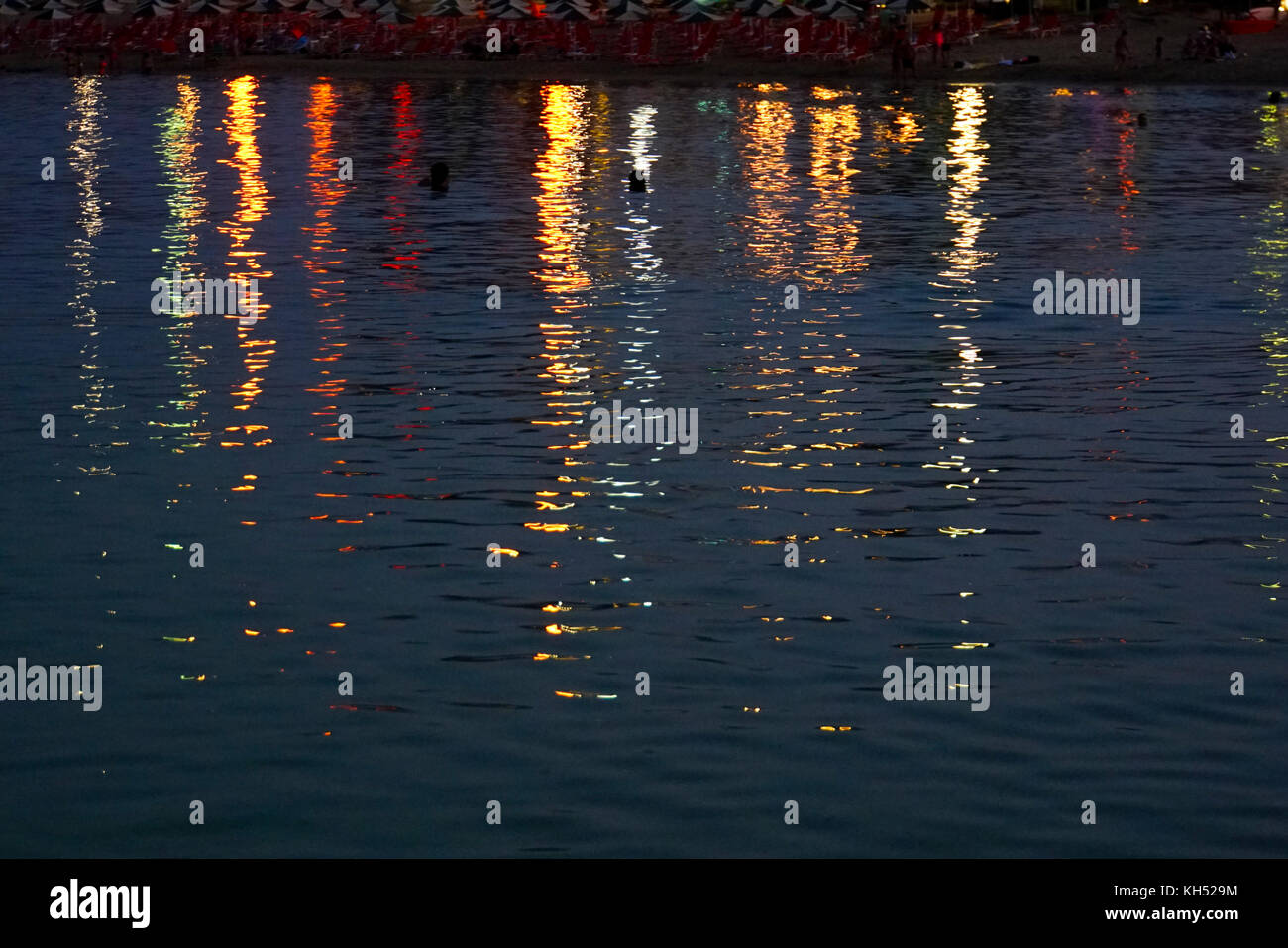 Colour lights reflecting in water in a harbour (Chania, Crete, Greece) Stock Photo