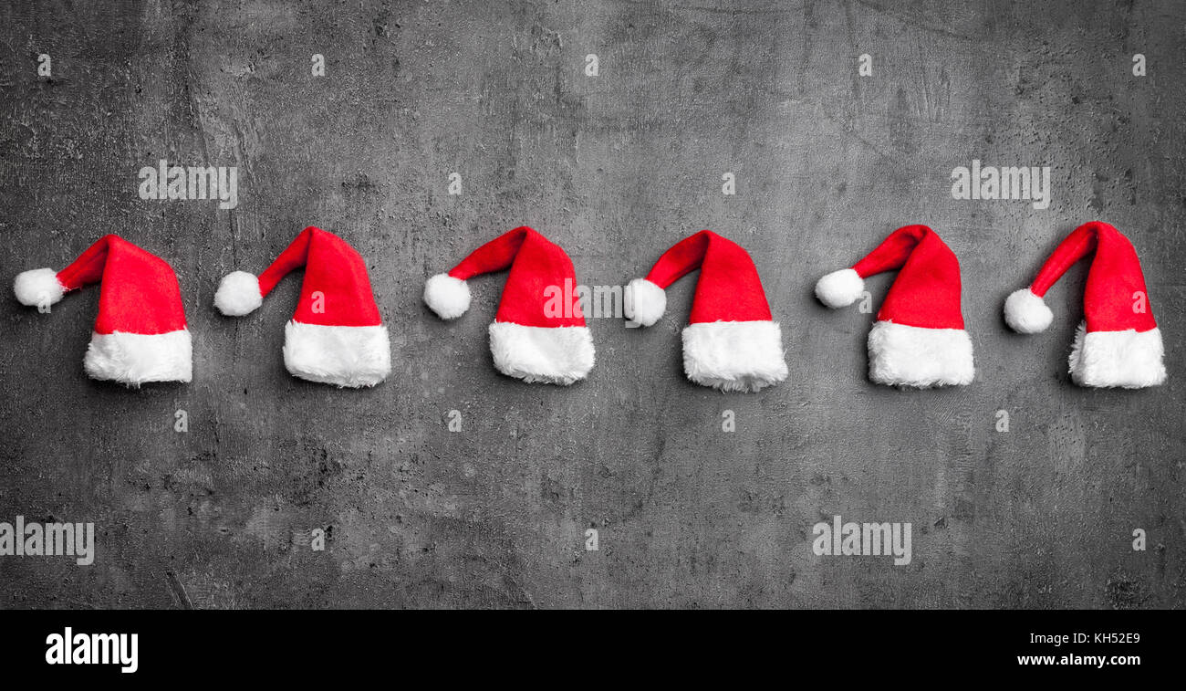 Traditional Christmas Santa hats on rustic background with copy space Stock Photo