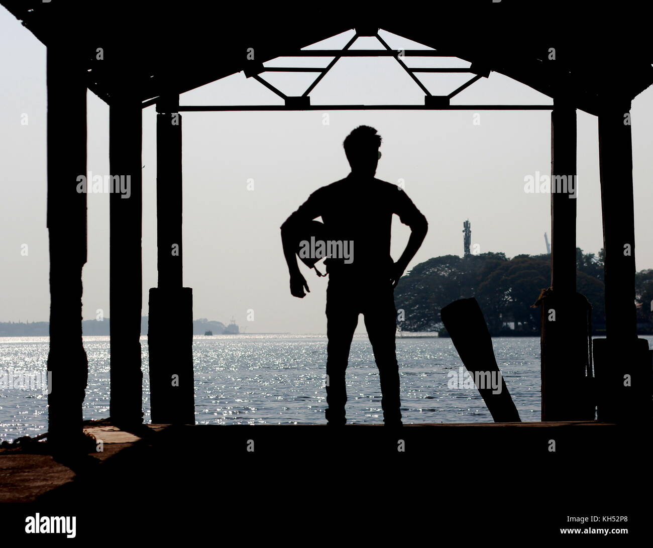 A youth standing near the ferry of Boat jetty Cochin. Stock Photo