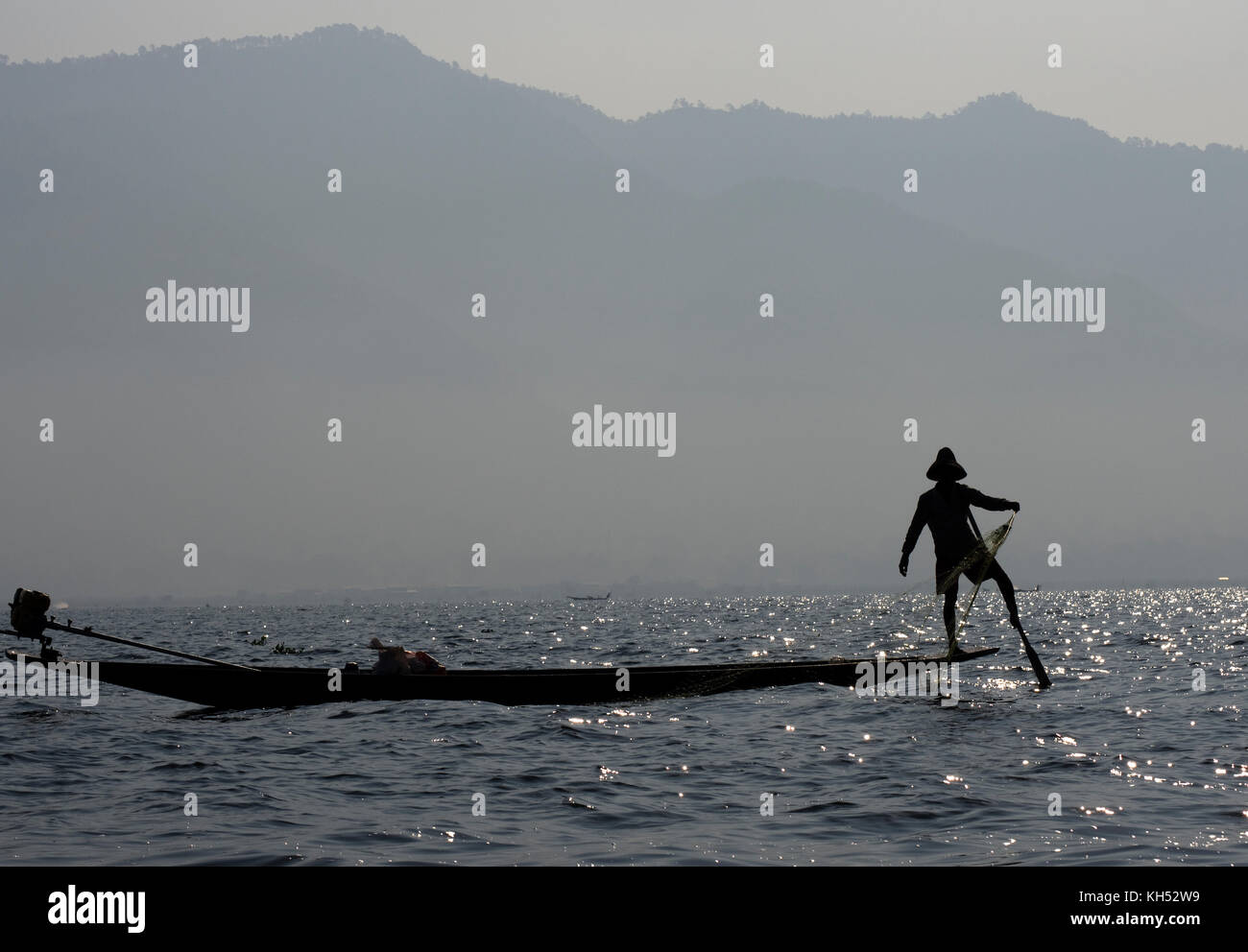 Fisherman rowing with one leg in Inle Lake Myanmar, Burma Stock Photo ...