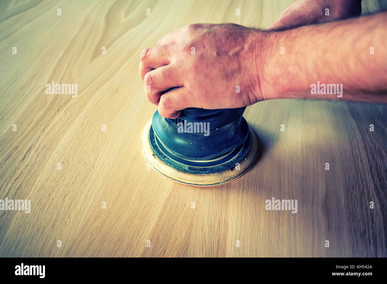 Man sanding wood with orbital sander in a Stock Photo Alamy