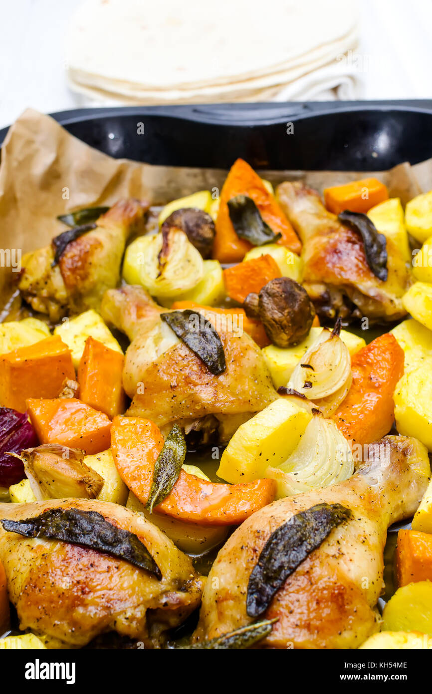 Roasted chicken legs with vegetables, herbs and pumpkin Stock Photo Alamy