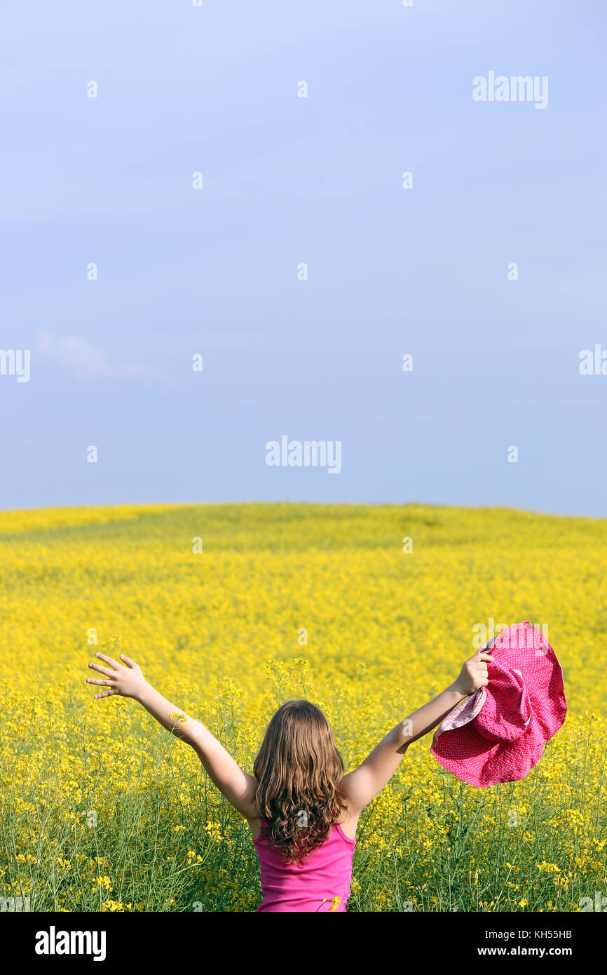 little girl on yellow field summer landscape Stock Photo - Alamy