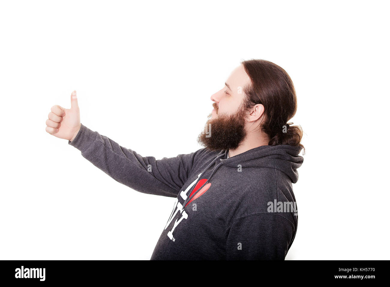side view bearded man with thumbs up expressing winning behavior Stock Photo