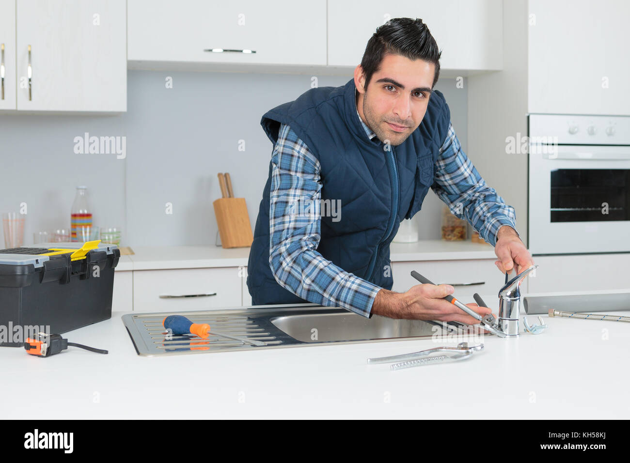 Portrait of plumber fitting tap Stock Photo Alamy